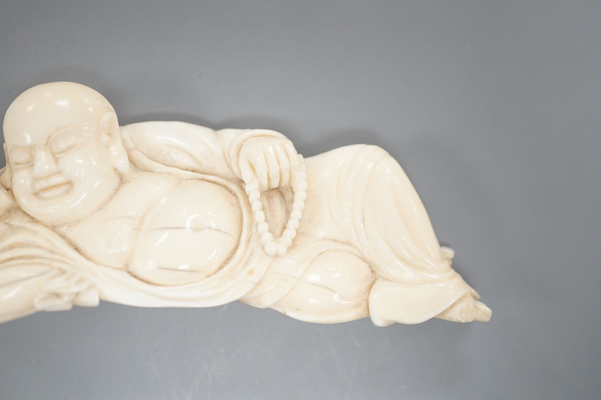 A 19th century Chinese carved ivory figure of Budai 11cm